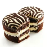 A side view of zebra cakes showing their striped frosting and creamy filling.