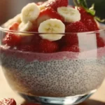 Strawberry Banana Chia Seed Pudding in a glass jar, topped with fresh fruits